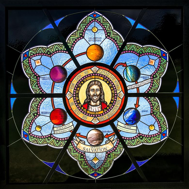 A stained and leaded glass sculpture by Matthew Hyrum Dell, depicting the Plan of Salvation.