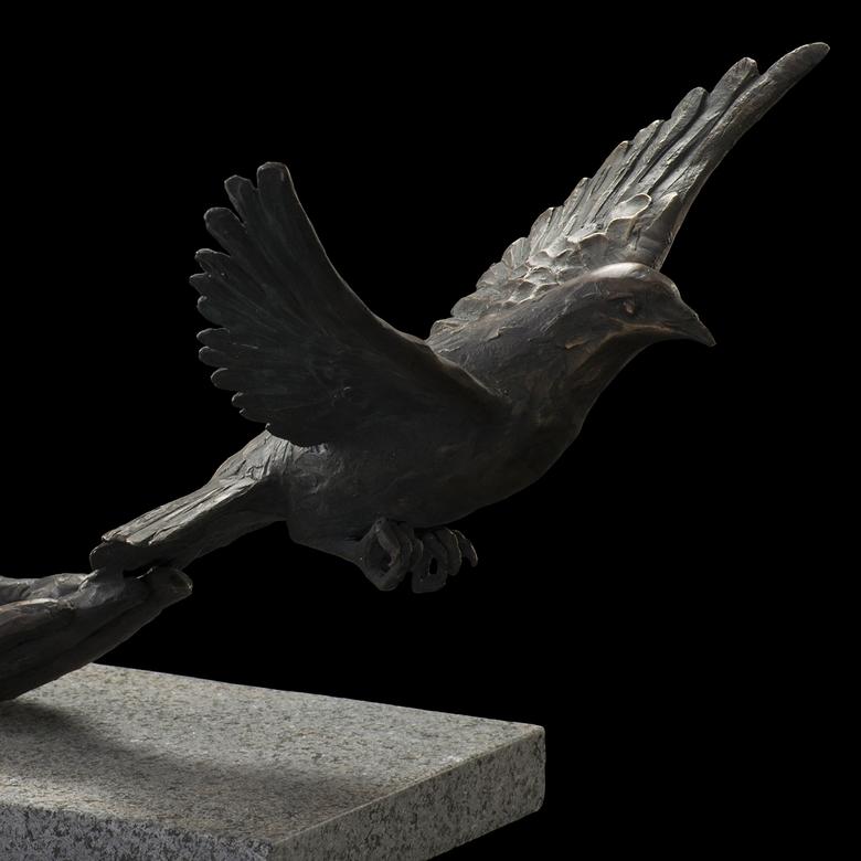 A cast bronze sculpture on a granite base by Brian Dean Christensen, depicting the Spirit of God descending like a dove.